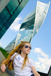 © olegator1977 - A cute girl in sunglasses and skyscrapers