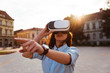 © bnenin - Portrait of young beautiful woman using 3d viewer outdoor in the city