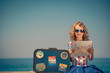 Child with vintage suitcase on summer vacation