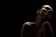 © tugolukof - beautiful topless woman with closed eyes on black background