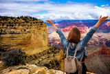 Fototapeta Sawanna - Women tourists wear jacket jeans at sunny light and blue sky at Grand Canyon  National Park , Arizona, USA