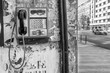 © Marco Taliani - An ancient public wall telephone covered in writing and drawings in the historic center of Bucharest, Romania, in black and white
