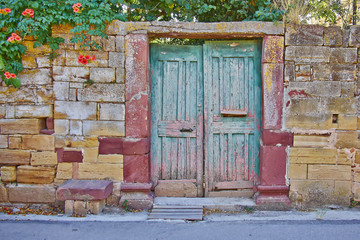 pale green door on vintage house stone wall facade