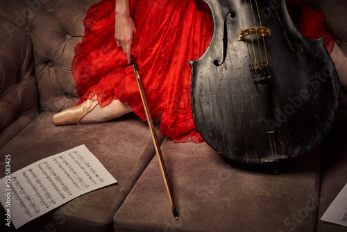 Plakat Żeński baletniczy tancerz w czerwieni smokingowym i pointe bawić się na antykwarskiej czarnej wiolonczeli