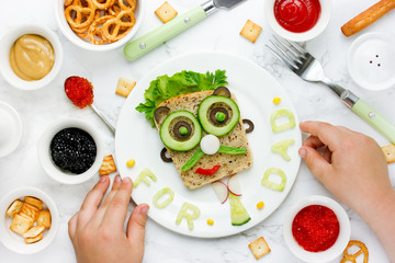 Child cooking for his dad breakfast for a gift on father's day