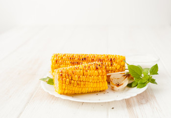 corn roasted on the grill and grilled onions