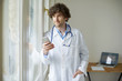 © gzorgz - Young doctor with mobile phone