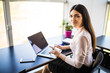 © F8  \ Suport Ukraine - Young beautiful woman using her laptop while sitting in chair at her working place