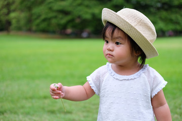 Cute Baby girl playing in the garden, close-up portrait, Portrait of Asian beautiful baby girl of 1 year and 3 months old.