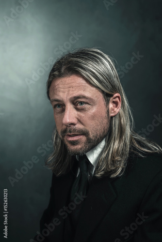 Retro Victorian Style Man With Blond Long Hair And Beard Wearing