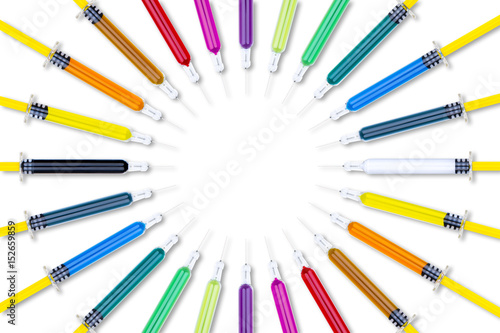 Stampe Multiple syringes with needles, filled with various colours of medicine/vaccines