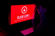 Computer Screen With Ransomware Attack File Encrypted Alerts In Red And A Man In Suit Get Stress In A Dark Room, Ideal For Online Security Failure And Digital Crime, Long Exposure Selective Focus