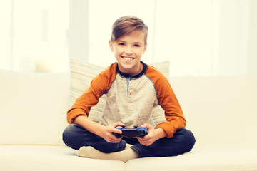 Wall Mural - happy boy with joystick playing video game at home