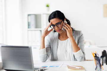 Wall Mural - stressed businesswoman with smartphone at office