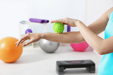 Hands Of Woman Doing Exercises With Rubber Ball In Clinic