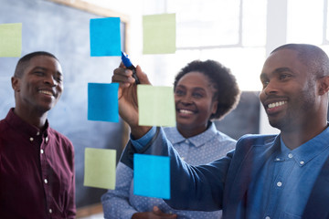 positive african work colleagues brainstorming together in an office