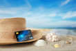 © Africa Studio - Sand with credit card and hat on white background