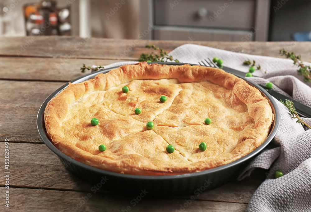 Baked chicken pot pie on wooden table