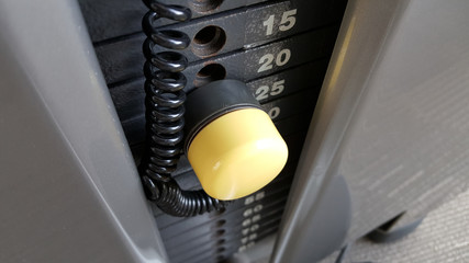 Gym weight plates with yellow pin.