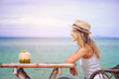 © romablack - Young woman using laptop on the beach. Freelance work