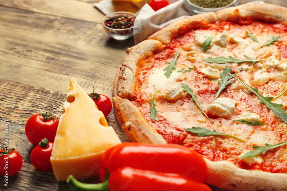 Fresh pizza Four Cheese with ingredients on wooden background close up