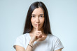 © Iurii - Keep silence! Beautiful young woman holding finger on lips