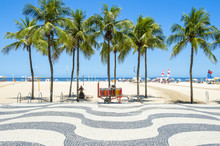 Bright Scenic View Of Copacabana Beach With Palm Trees Beside The Iconic Boardwalk In Rio De Janeiro, Brazil