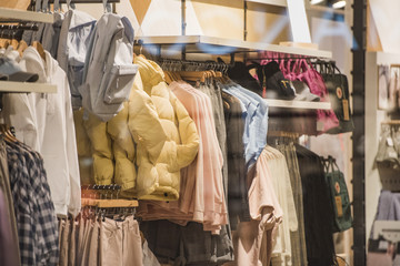 Wall Mural - Women clothes on hangers in a store in London.