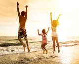 Fototapeta  - happy Family jumping on the beach.
