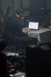 Man using laptop in dark room.