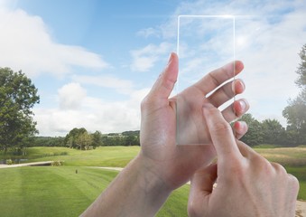 Canvas Print - Hand Touching Glass Tablet in nature park with sky