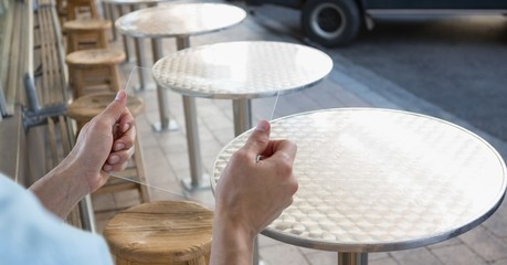 Canvas Print - Hands holding transparent device at sidewalk cafe