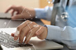 © everythingpossible - close up of smart medical doctor working with laptop computer and mobile phone and stethoscope on dark wooden desk with virtual reality icon diagram