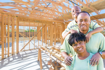 Young African American Family On Site Inside Their New Home Construction Framing.