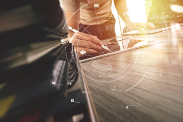 Poster - creative working with mobile phone and digital tablet and laptop computer on wooden desk in modern office with virtual icon diagram