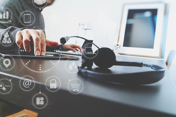 Man using VOIP headset with digital tablet computer as concept communication or it support or call center and customer service in modern office