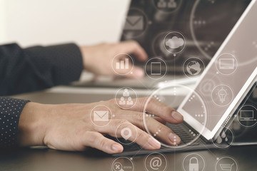 Poster - close up of businessman hand working with laptop and digital docking keyboard tablet computer in modern office