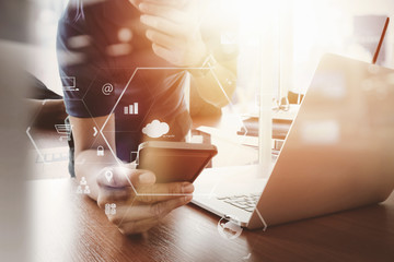 Poster - businessman working with mobile phone and digital tablet and laptop computer on wooden desk in modern office with VR icon diagram