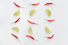 Pattern Of Red Hot Chili Peppers And Sliced Limes On A White Background. Asian Species.