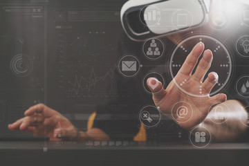 businessman working with mobile phone and digital tablet and laptop computer on wooden desk in modern office with virtual icon diagram