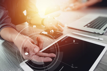 Poster - creative working with mobile phone and digital tablet and laptop computer on wooden desk in modern office with virtual icon diagram