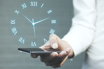 Canvas Print - Businessman hand phone  with  clock