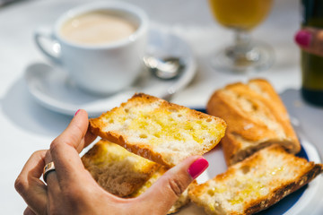 Woman holding oiled toast