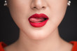 © makistock - Beauty. Close up view of beautiful woman lips with red matt lipstick licking her desire