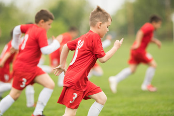 Kids soccer football - children players exercising before match on soccer field