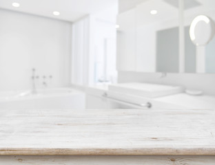 Wall Mural - background of blurred bathroom interior with wooden table in front