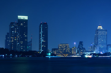 bangkok city skyline from the Chao Phraya River by night Light passing