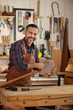 © dzhafarov_eduard - Carpenter Finishing Wooden Horse Toy/Middle aged handsome carpenter  making final touches to the Horse Toy