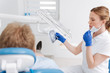 Skillful scrupulous dentist analyzing patients xray