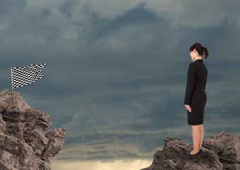 Wall Mural - Businesswoman looking at checked flag against sky